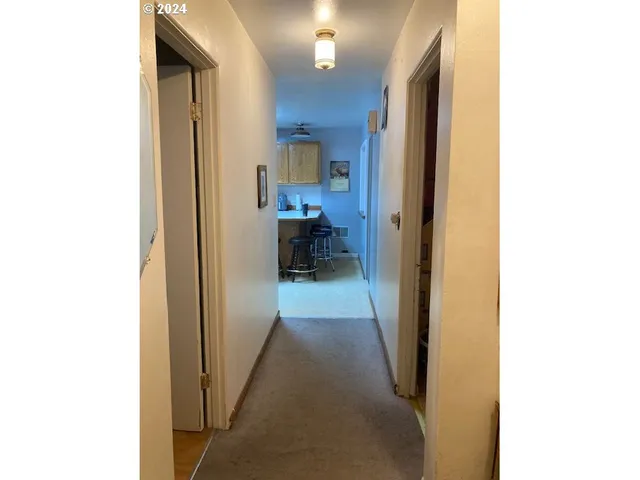 a view of a hallway with a living room