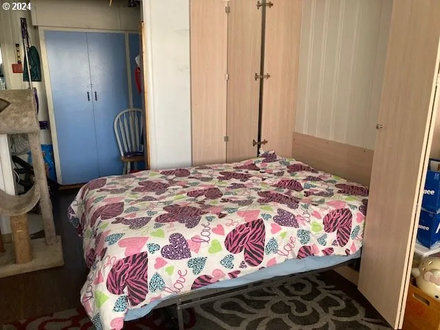 a bedroom with a bed and a mirror