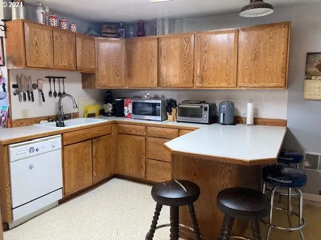 a kitchen with a sink a stove a table and chairs