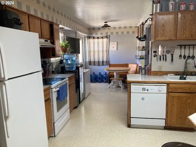 a kitchen with refrigerator and cabinets