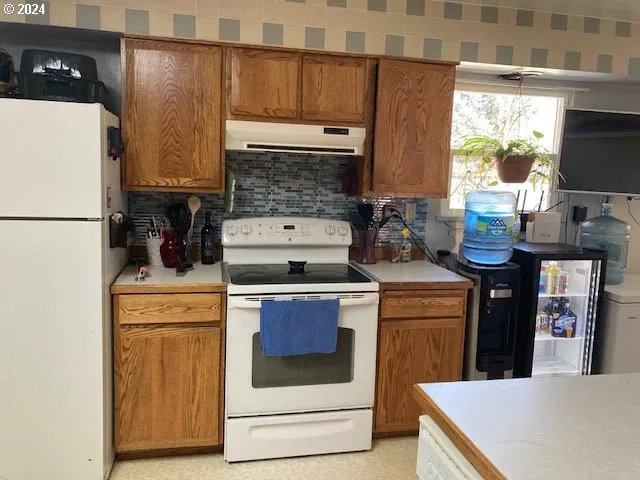 a kitchen with stainless steel appliances granite countertop a stove and a refrigerator