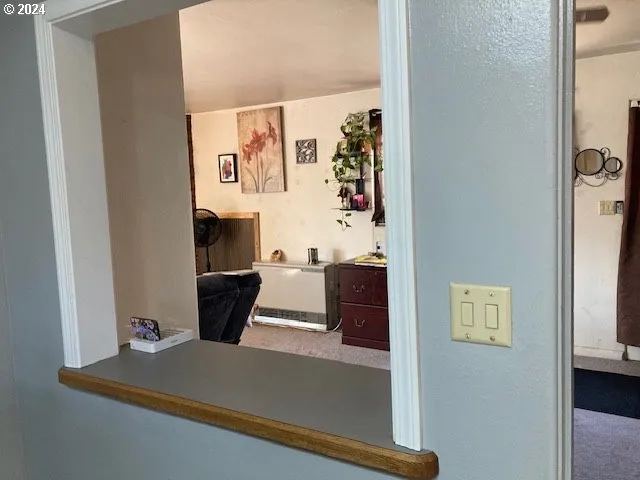 a view of a hallway with paintings on the wall