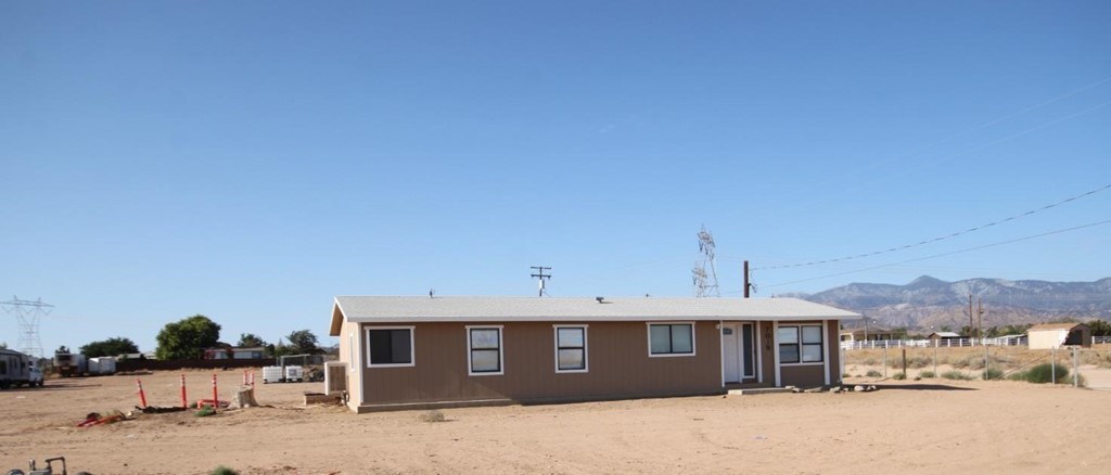 7019 Phelan Road Phelan, CA 92371 - Photo 1 of 1 a front view of a house with a yard