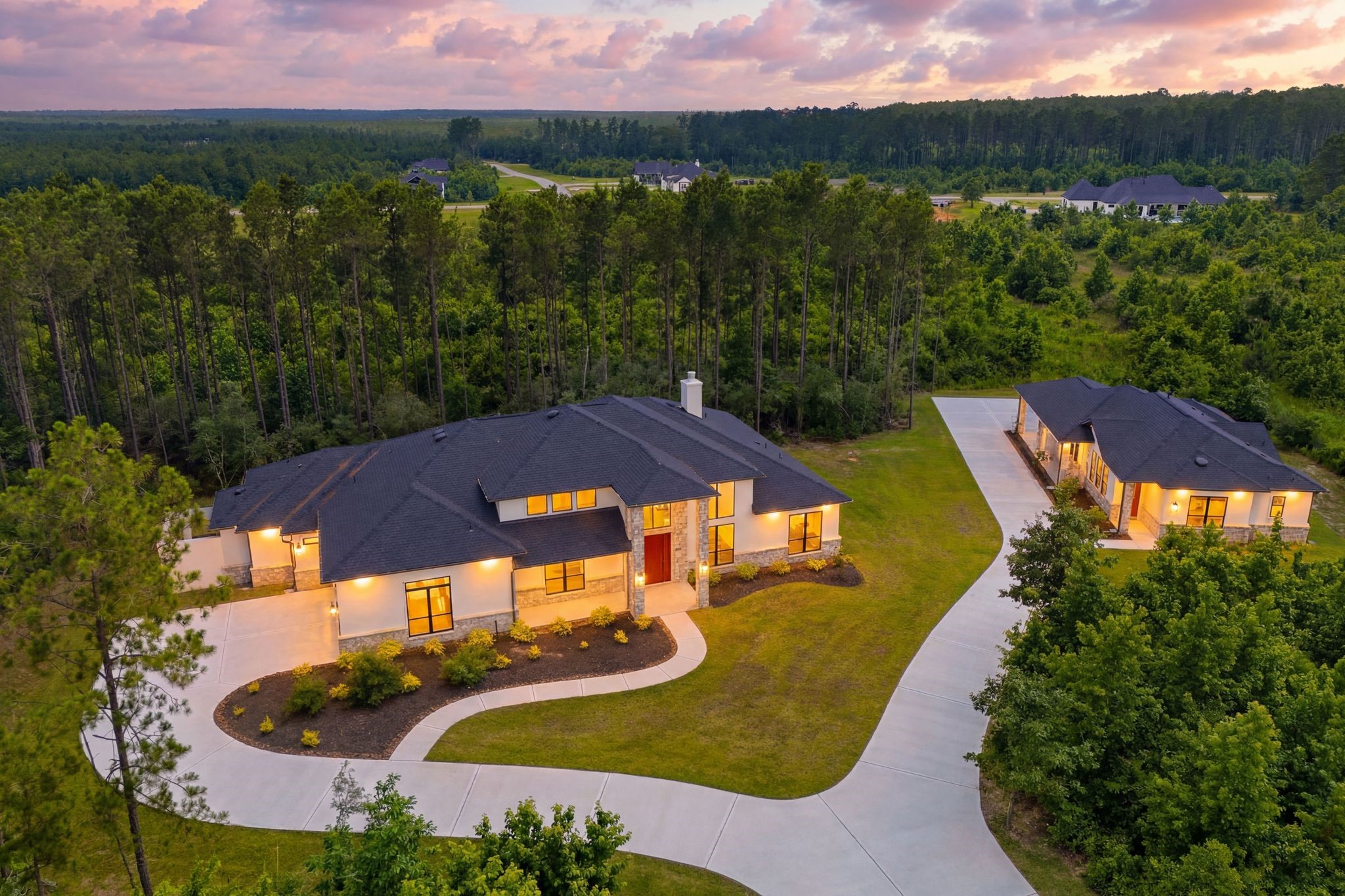 Exceptional 4.53 acre wooded retreat featuring a luxury main home, separate guest house, and epansive grounds designed for privacy, comfort, and flexible living.