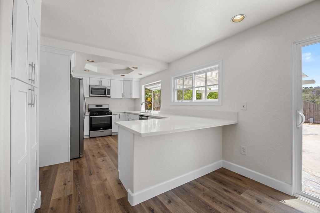 4595 Blackwell Road Oceanside, CA 92056 - Photo 12 of 47 a kitchen with a refrigerator and a stove top oven