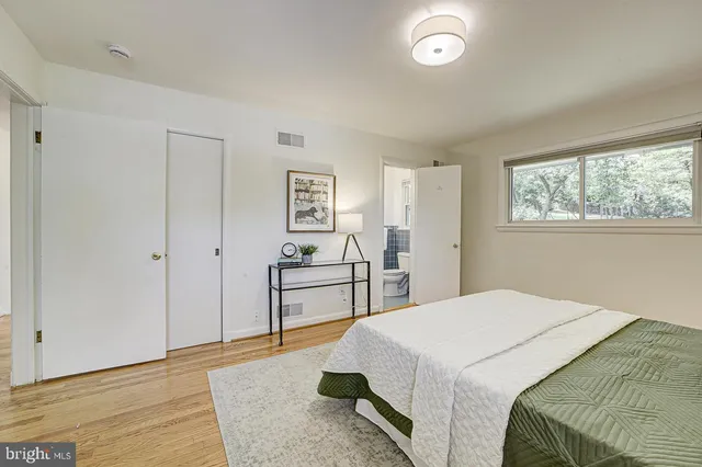 a bedroom with a bed and a table
