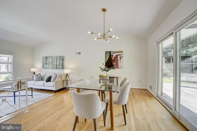 a living room with furniture a window and a chandelier