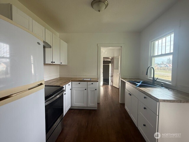 306 South 6th Street Satsop, WA 98541 - Photo 6 of 13 a kitchen with granite countertop stainless steel appliances a sink stove top oven and cabinets