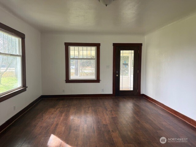 306 South 6th Street Satsop, WA 98541 - Photo 8 of 13 an empty room with wooden floor and windows