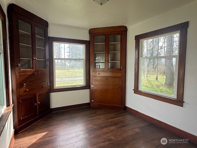306 South 6th Street Satsop, WA 98541 - Photo 9 of 13 an empty room with wooden floor and windows