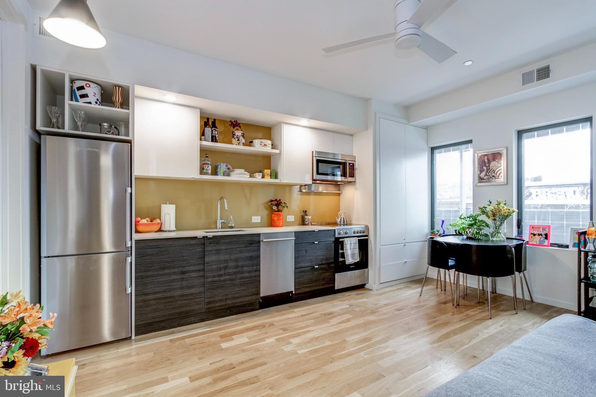 1942 North Front Street, Unit 206 Philadelphia, PA 19122 - Photo 5 of 14 a kitchen with stainless steel appliances granite countertop a refrigerator and a sink