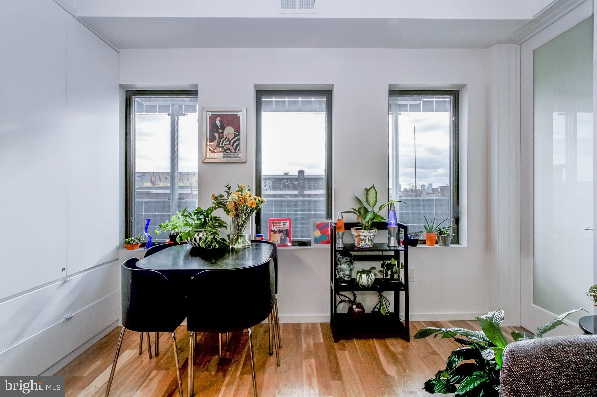 1942 North Front Street, Unit 206 Philadelphia, PA 19122 - Photo 6 of 14 a living room with furniture and flowers