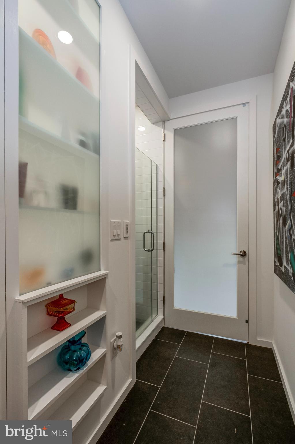 1942 North Front Street, Unit 206 Philadelphia, PA 19122 - Photo 8 of 14 a bathroom with a glass door shower and a sink