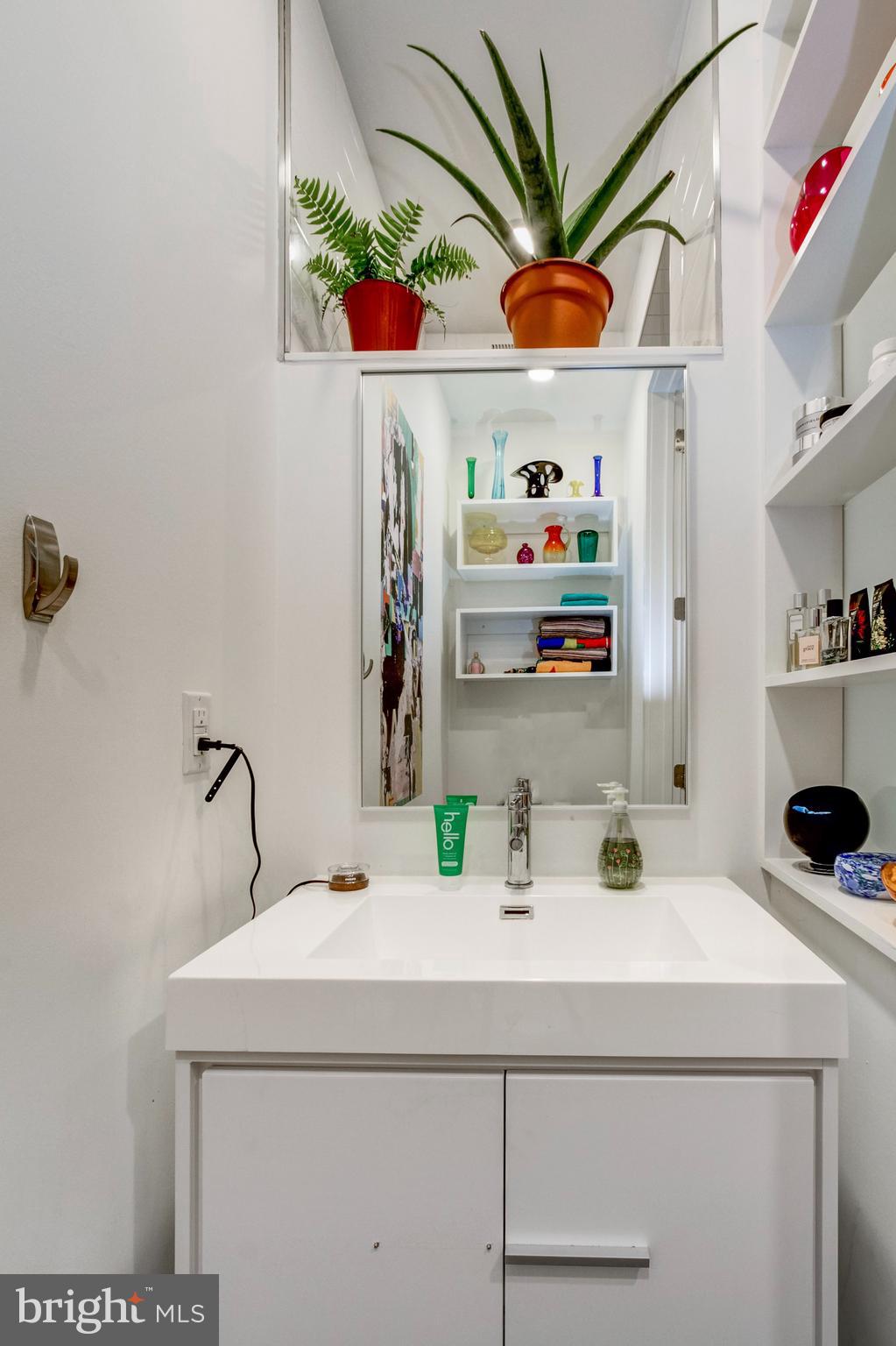 1942 North Front Street, Unit 206 Philadelphia, PA 19122 - Photo 10 of 14 a bathroom with a sink a mirror and vanity