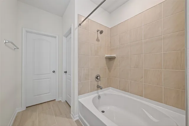 a bathroom with a bathtub and shower