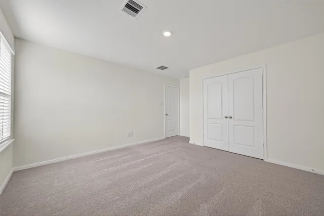 a view of an empty room and a window