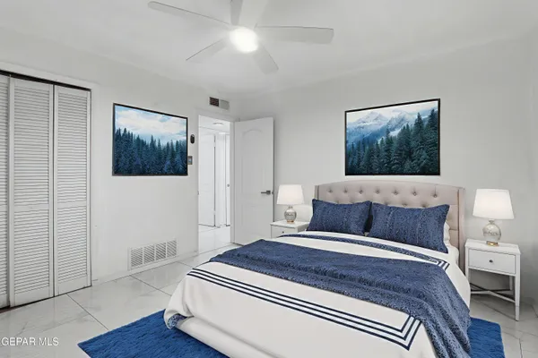 a bedroom with a bed and a painting on the wall