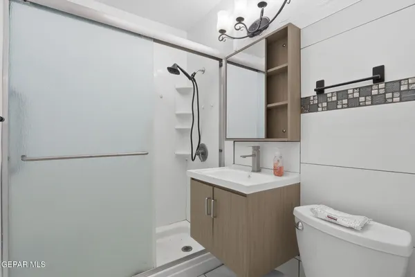 a bathroom with a sink toilet and mirror