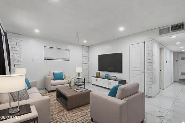 a living room with furniture and a flat screen tv