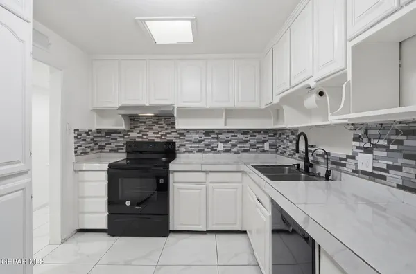 a kitchen with stainless steel appliances granite countertop a sink and a stove