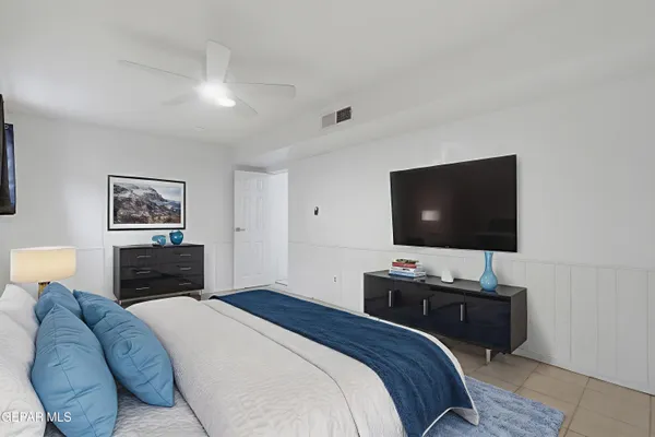 a bedroom with a bed and a flat screen tv