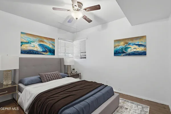 a bedroom with a bed and a painting on the wall