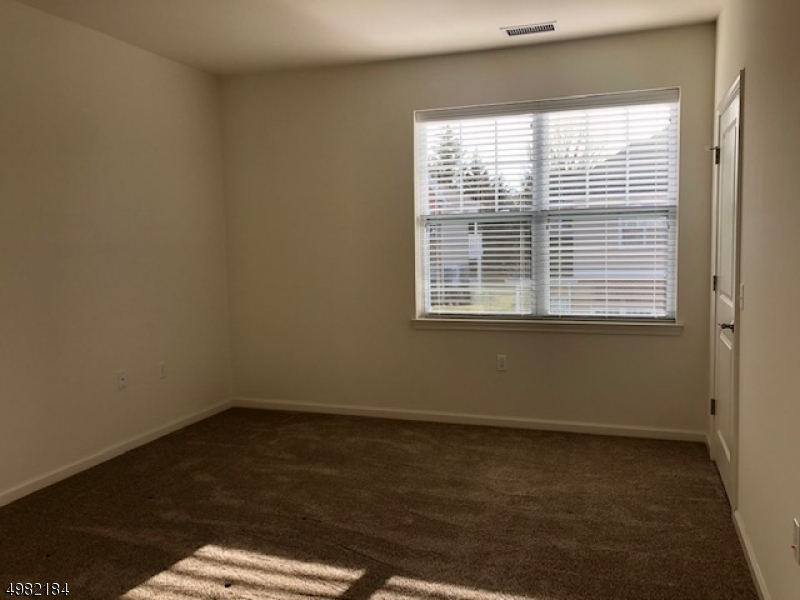 60 Passaic Avenue, Unit 22 Fairfield, NJ 07004 - Photo 5 of 13 a view of a room that has a window in it