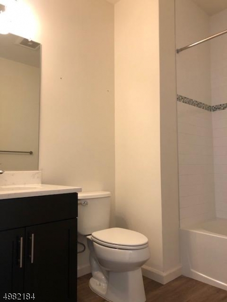 60 Passaic Avenue, Unit 22 Fairfield, NJ 07004 - Photo 6 of 13 a bathroom with a sink a toilet and shower