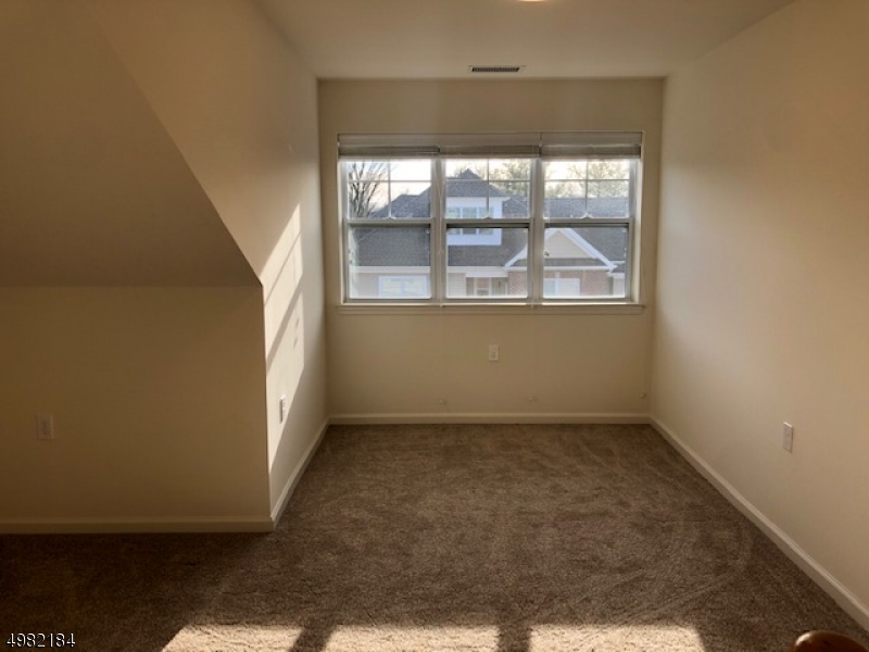 60 Passaic Avenue, Unit 22 Fairfield, NJ 07004 - Photo 10 of 13 an empty room with a window