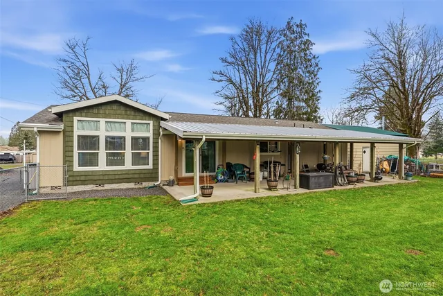 a front view of a house with a garden and patio