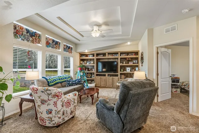 a living room with furniture large window and flat screen tv