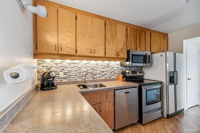 a kitchen with a sink a stove and refrigerator