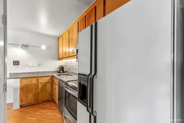a kitchen with a sink cabinets and stainless steel appliances