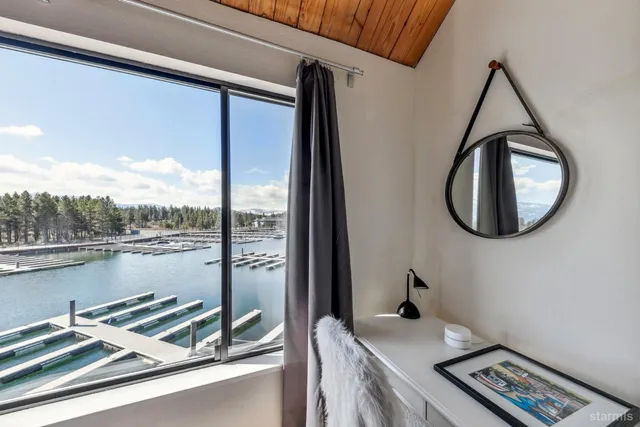 a view of a balcony with a bed and a bookshelf
