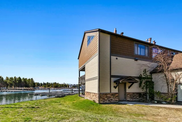a backyard of a house with lots of green space and outdoor seating