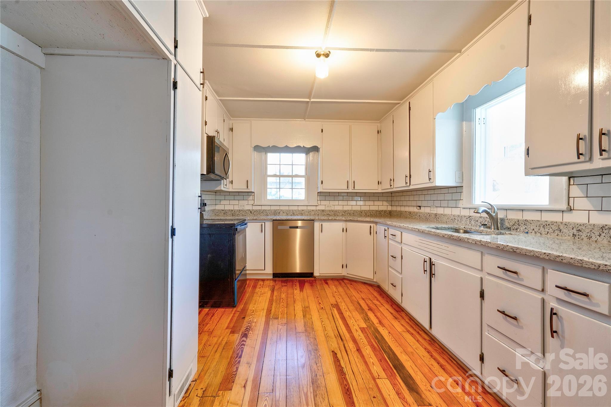171 Center Street Spindale, NC 28160 - Photo 32 of 34 a view of a kitchen with a sink and wooden floor