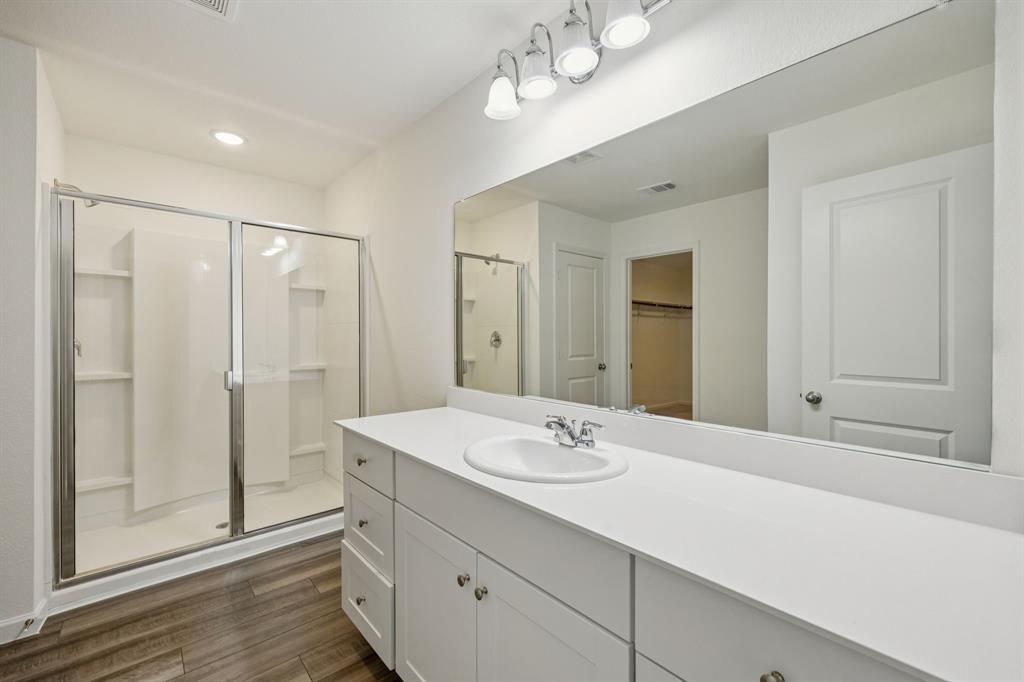 1902 Marquette Road Princeton, TX 75407 - Photo 25 of 30 a bathroom with a double vanity sink mirror and shower