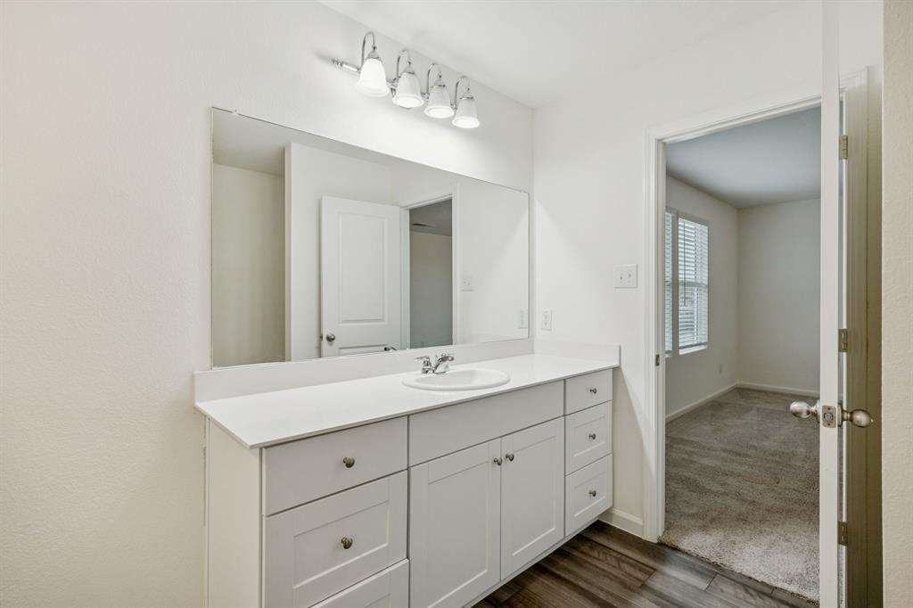 1902 Marquette Road Princeton, TX 75407 - Photo 26 of 30 a spacious bathroom with a double vanity sink and mirror