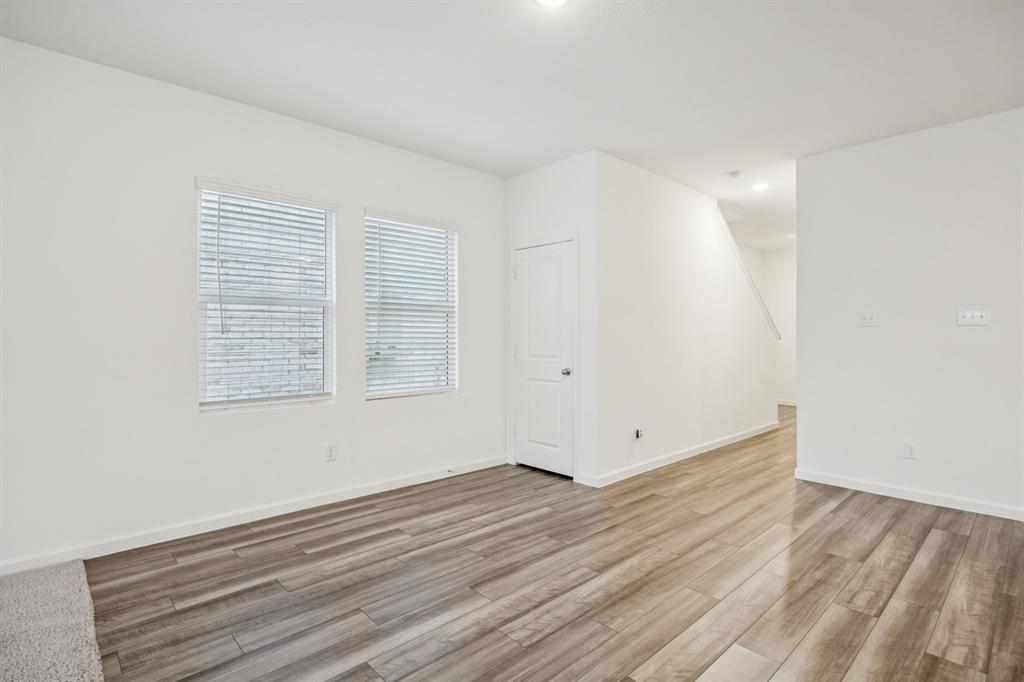 1902 Marquette Road Princeton, TX 75407 - Photo 8 of 30 a view of an empty room with wooden floor and a window