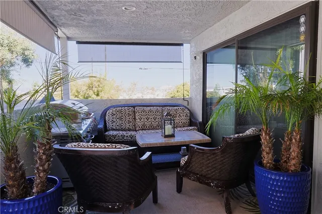 a outdoor living room with furniture and a potted plant
