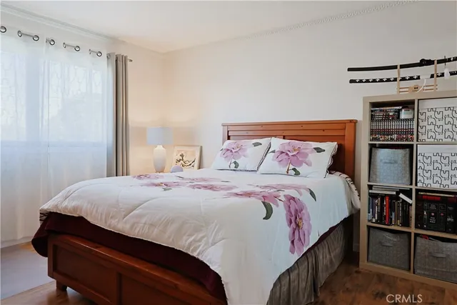 a bedroom with a bed and a night stand