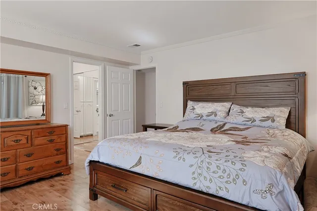 a bedroom with a bed and a dresser