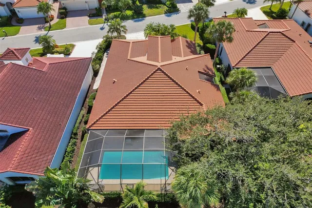 an aerial view of a house with a yard and potted plants