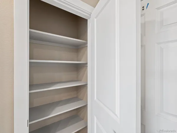 a view of walk in closet with empty racks