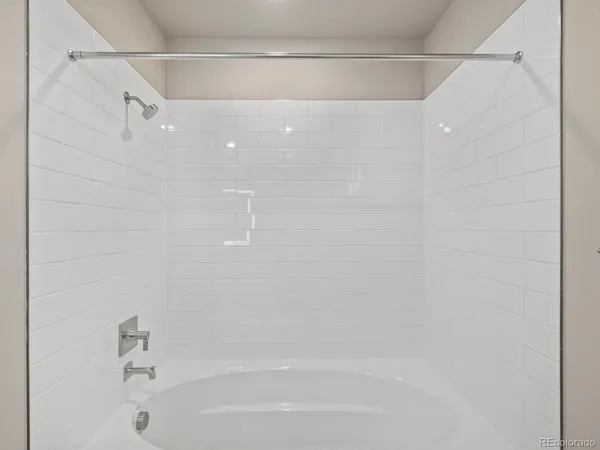 a bathroom with a shower and a bath tub