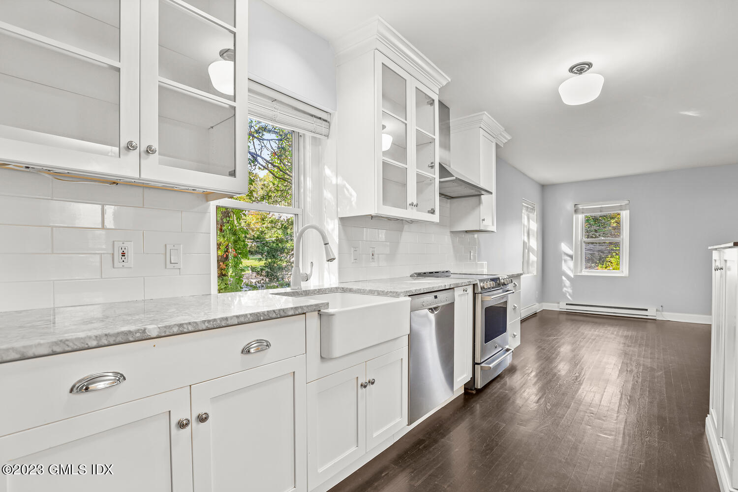 436 Valley Road Cos Cob, CT 06807 - Photo 1 of 1 a kitchen with white cabinets and wooden floor
