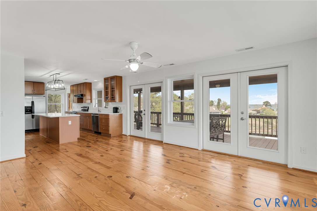 1667 Locust Grove Road Topping, VA 23169 - Photo 15 of 45 Kitchen with french doors, brown cabinetry, light