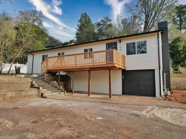 a backyard of a house with table and chairs