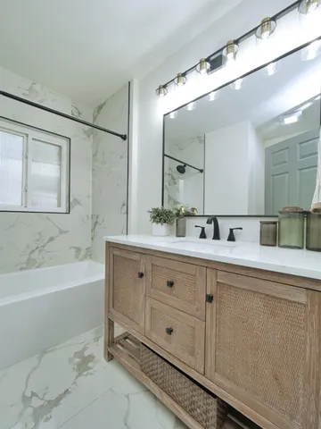 a bathroom with a double vanity sink mirror double and bathtub