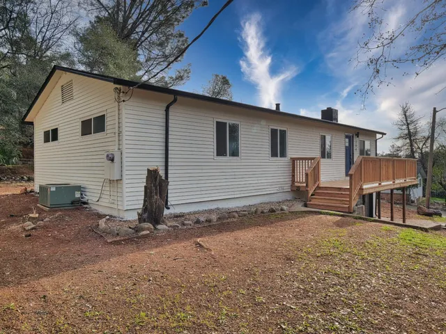a view of a house with a yard and sitting area